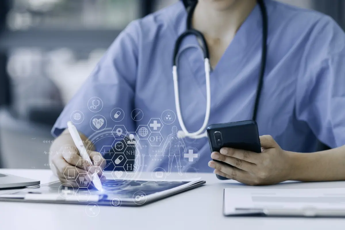 Medical professional using tablet and smartphone.