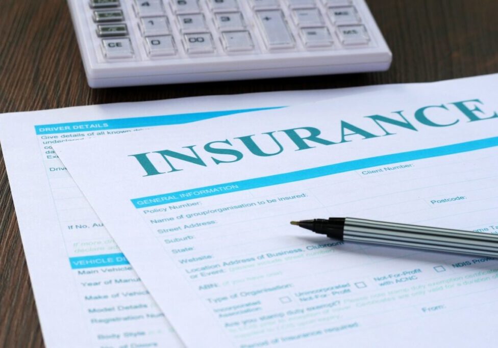 Insurance form with pen and calculator.