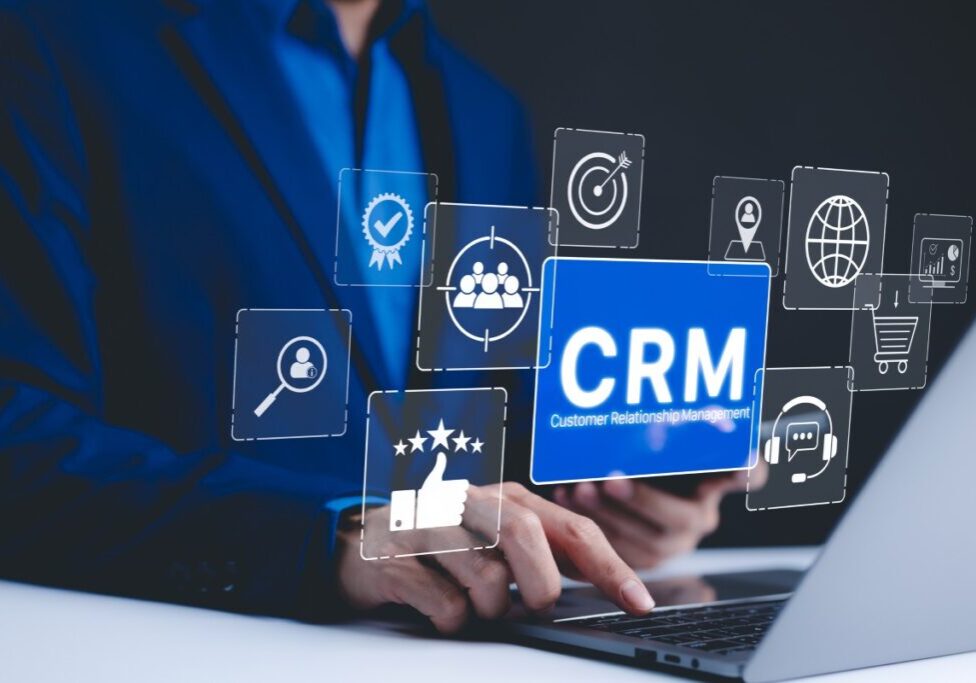 Person using CRM software on laptop.